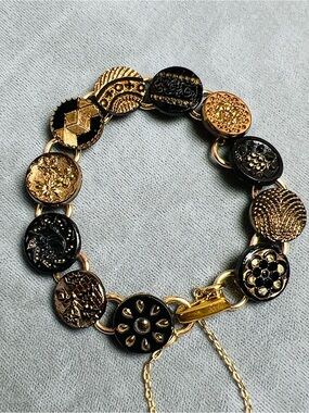 Antique button bracelet, gold luster black glass, fold over clasp, safety chain